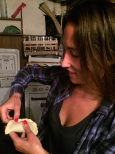Lorena teaching me techniques on how to fold the outer edges of the empanadas.
